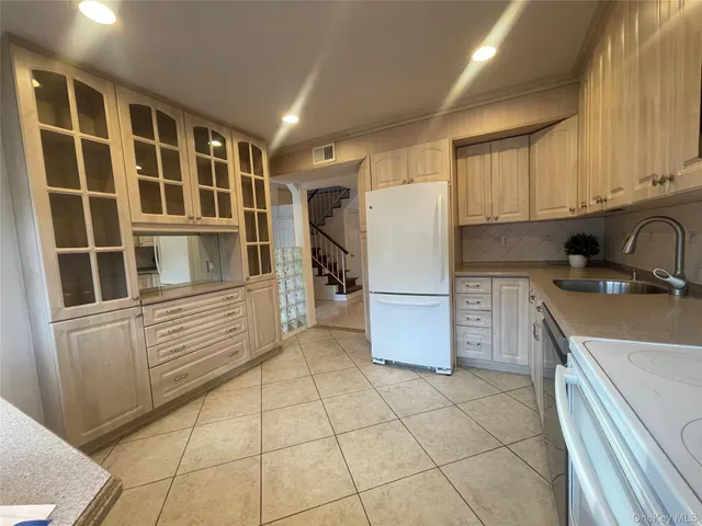 a living room with furniture and stairs