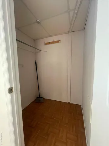 a bathroom with a white toilet sitting next to a bathroom sink and a mirror