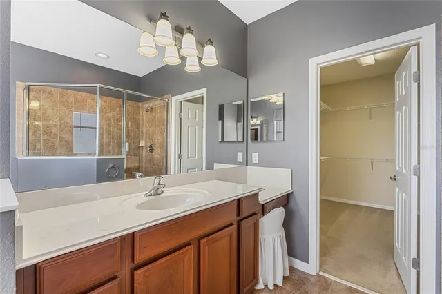 an empty room with ceiling fan and windows