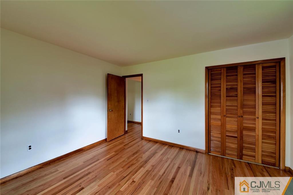 65 Long Hill Road Colonia, NJ 07067 - Photo 13 of 16 wooden floor in an empty room