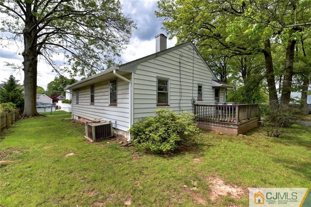 65 Long Hill Road Colonia, NJ 07067 - Photo 15 of 16 a backyard of a house with table and chairs