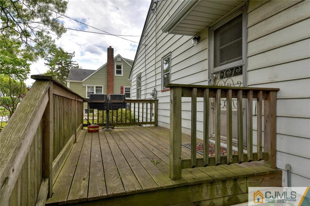 65 Long Hill Road Colonia, NJ 07067 - Photo 3 of 16 a view of a balcony with wooden floor and fence
