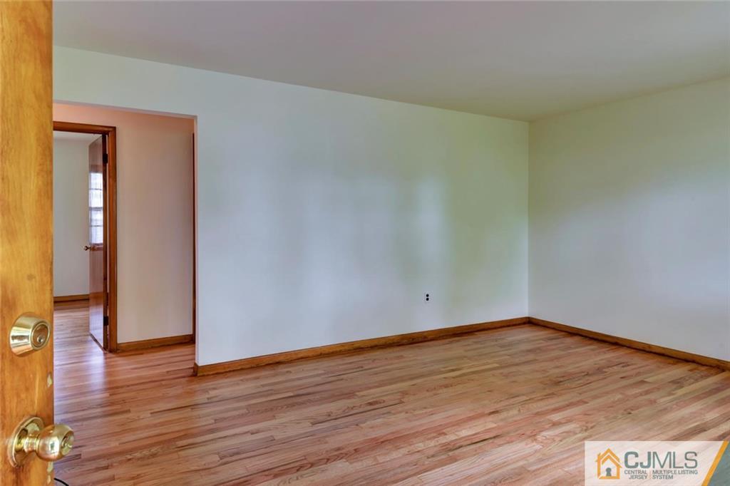 65 Long Hill Road Colonia, NJ 07067 - Photo 4 of 16 a view of an empty room and wooden floor