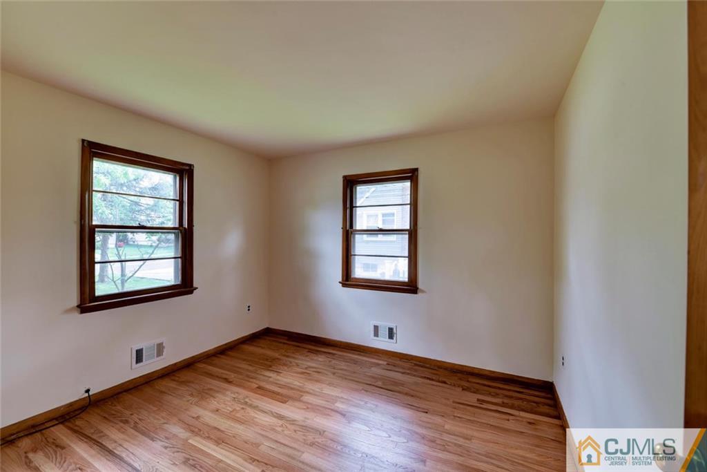 65 Long Hill Road Colonia, NJ 07067 - Photo 8 of 16 wooden floor in an empty room with a window