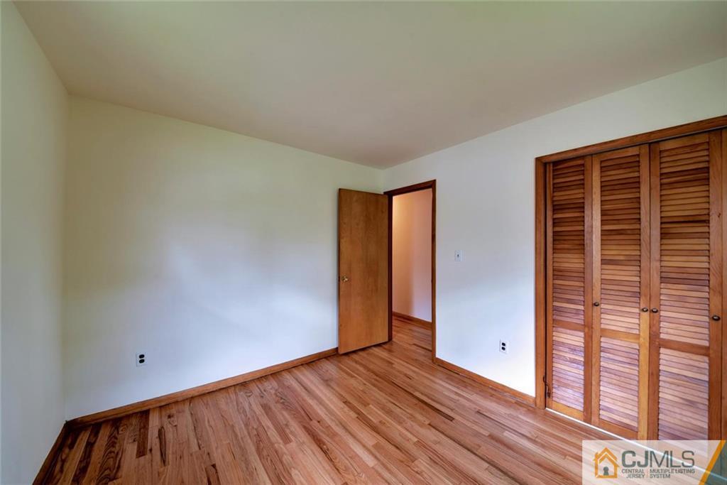 65 Long Hill Road Colonia, NJ 07067 - Photo 9 of 16 a view of empty room with wooden floor and fan