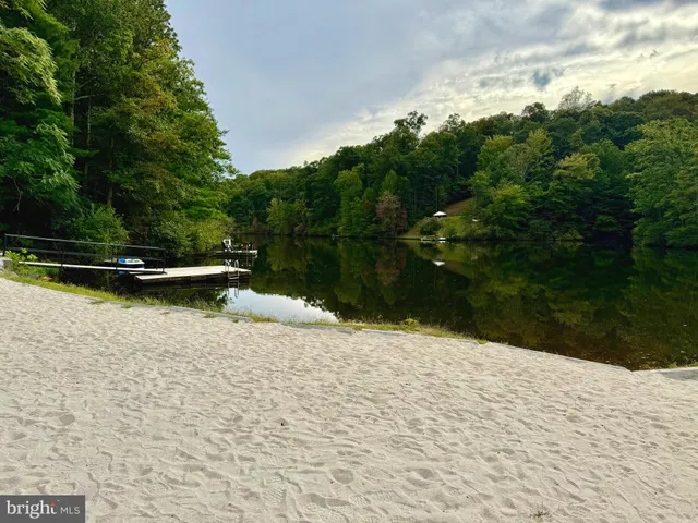 a wooden bench sitting in the middle of a lake