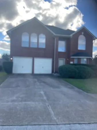 a view of a house with a yard and garage