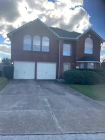 a view of a house with a yard and garage