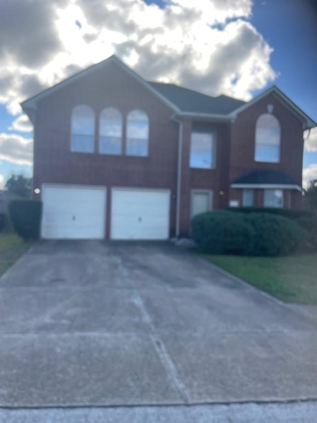 a view of a house with a yard and garage