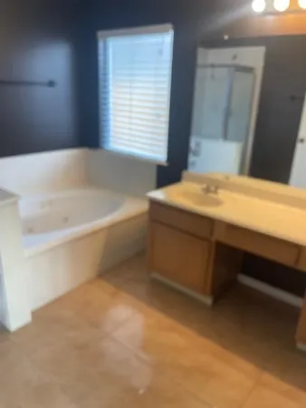 a bathroom with a bathtub and a window