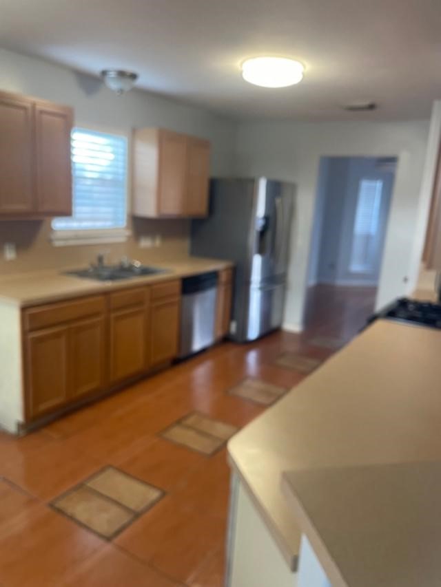 2219 Beacon Light Lane Fresno, TX 77545 - Photo 5 of 23 a view of a kitchen with a sink and dishwasher a stove top oven with wooden floor