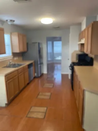 a kitchen with a sink a stove and cabinets