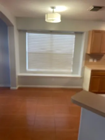 a view of a livingroom with an empty space and a window