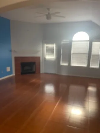 a view of empty room with window and fireplace
