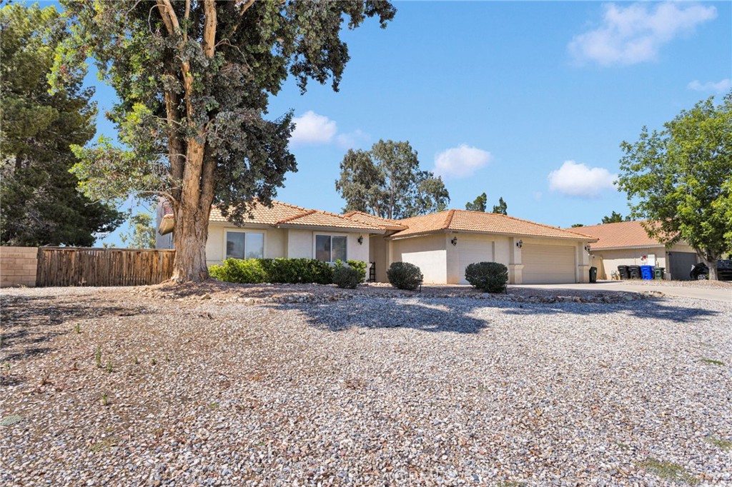 20403 Ochoa Road Apple Valley, CA 92307 - Photo 3 of 48 a front view of a house with a yard