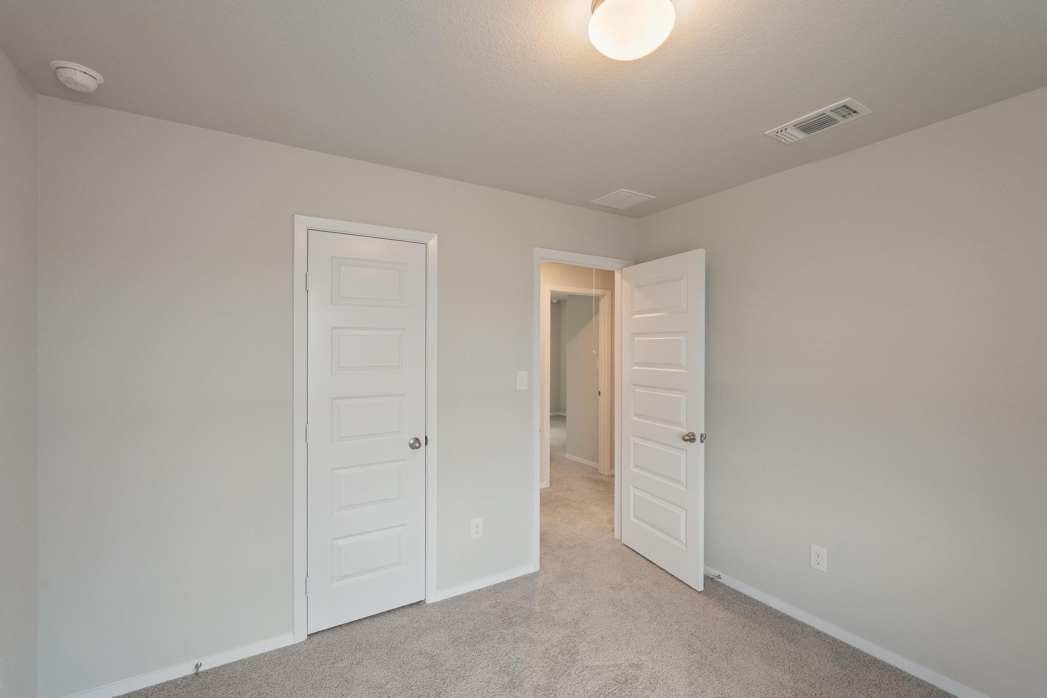 2812 Steels Road Manor, TX 78653 - Photo 20 of 25 Soft carpeting pairs with neutral walls in this versatile guest bedroom.