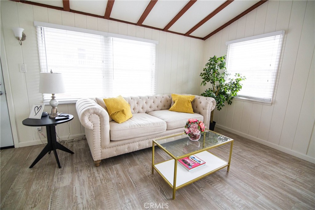 626 Eucalyptus Drive, Unit 1/2 El Segundo, CA 90245 - Photo 3 of 7 a living room with furniture and a potted plant