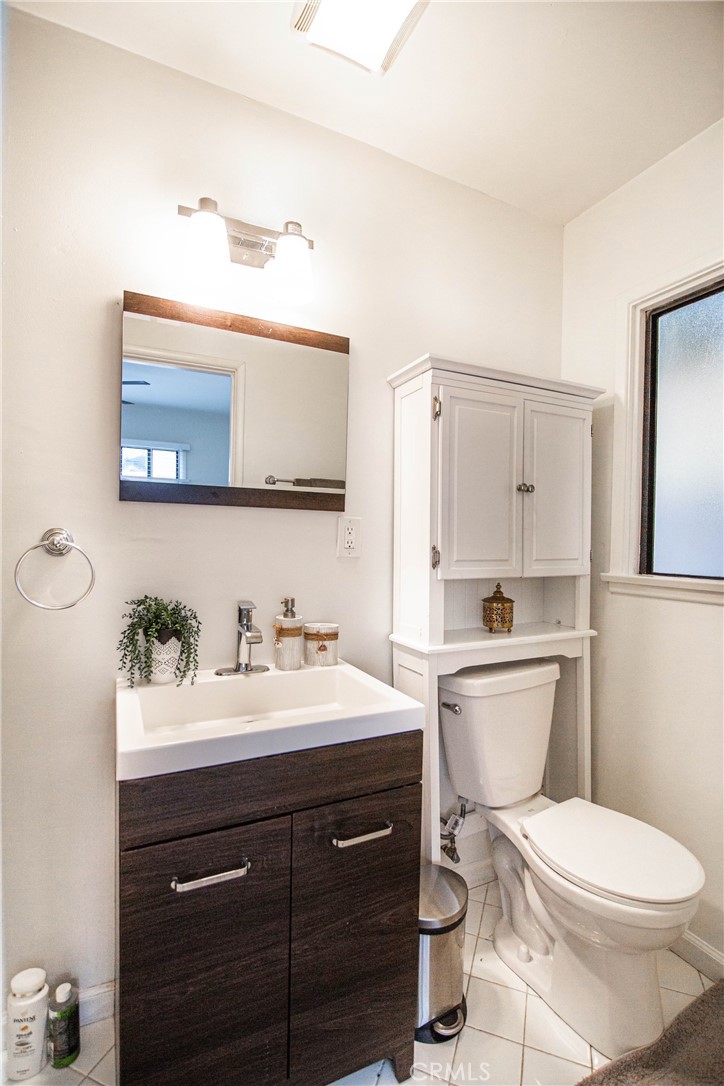 626 Eucalyptus Drive, Unit 1/2 El Segundo, CA 90245 - Photo 4 of 7 a bathroom with a toilet a sink and mirror