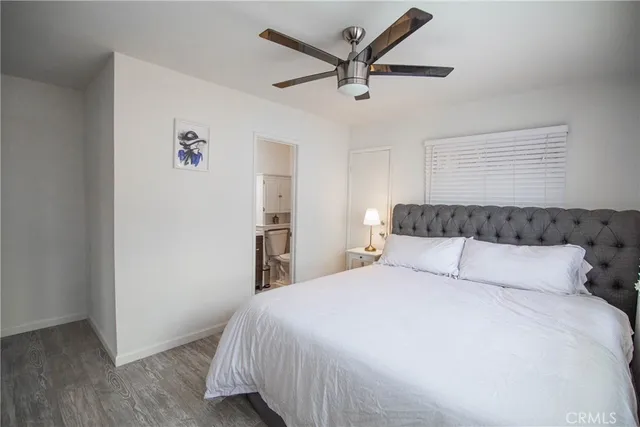 a bedroom with a large bed and a chandelier