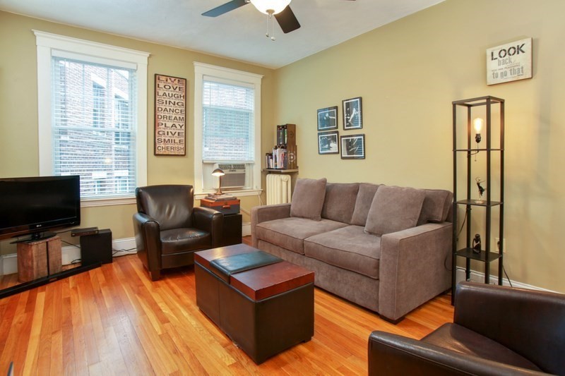130 Sutherland Road, Unit 11 Boston, MA 02135 - Photo 3 of 7 a living room with furniture and a flat screen tv