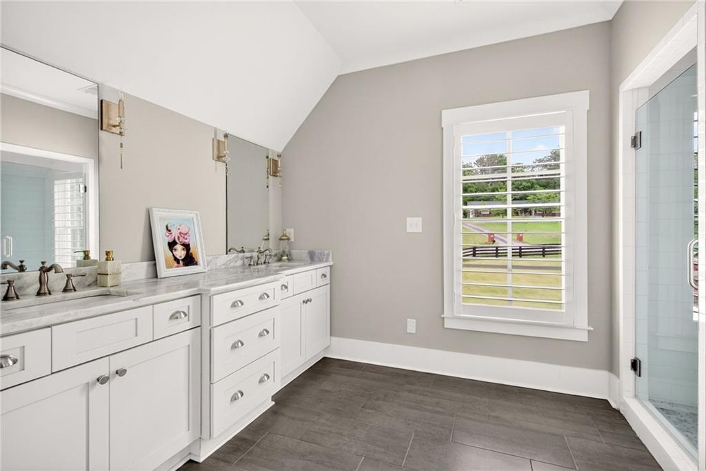 13460 New Providence Road Milton, GA 30004 - Photo 26 of 60 a spacious bathroom with double sink large mirror a next to a window