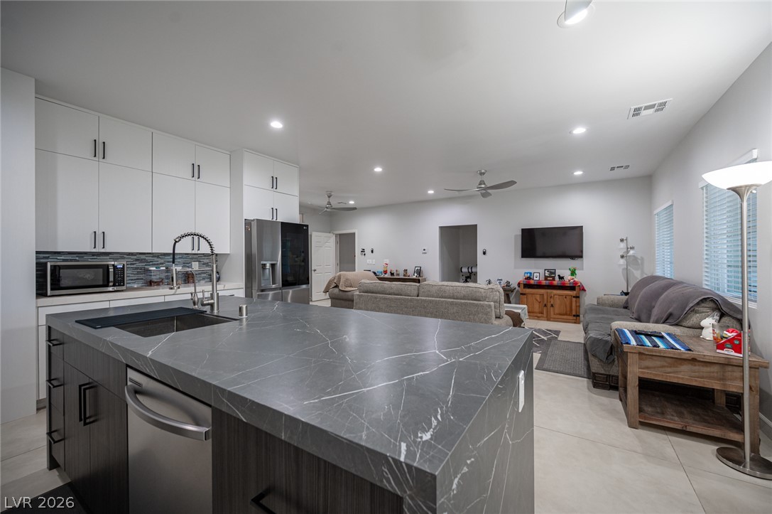 441 Belville Road Pahrump, NV 89048 - Photo 16 of 44 Seamlessly integrating modern design with comfort, this open-concept space features a well-appointed kitchen flowing into a bright living area.