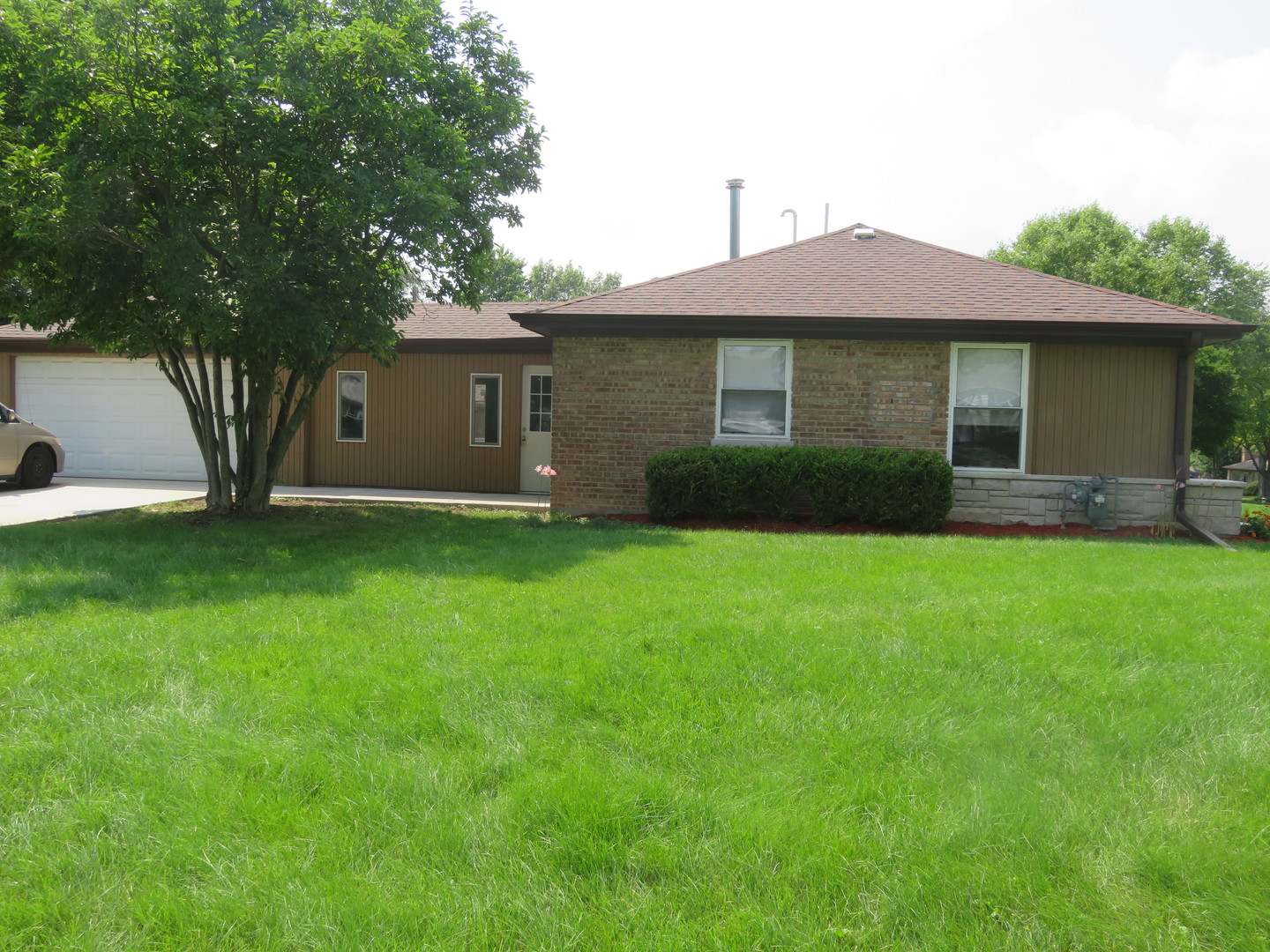 2441 Hawthorne Road Homewood, IL 60430 - Photo 2 of 23 a front view of a house with a yard and garage