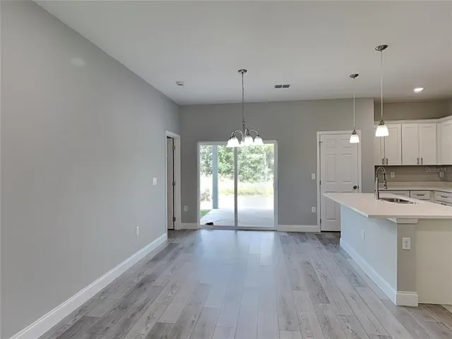 a view of a kitchen with a stove cabinets and a wooden floor