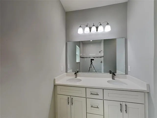 a bathroom with a sink and a mirror