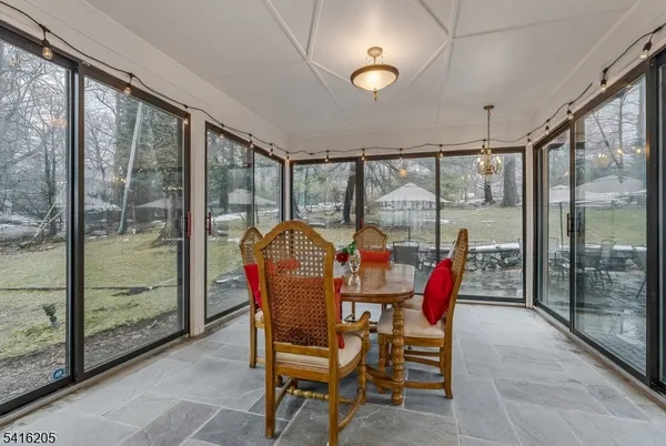 a dining room with furniture water view and a large window