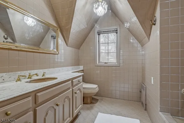 a bathroom with a granite countertop sink a toilet and a mirror