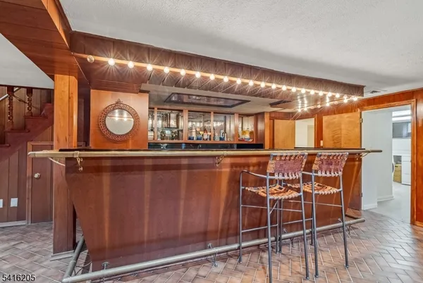 a kitchen with stainless steel appliances granite countertop a table chairs and wooden floor