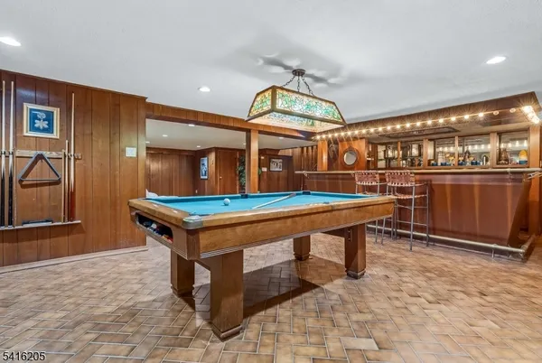a room with table chairs and wooden floor