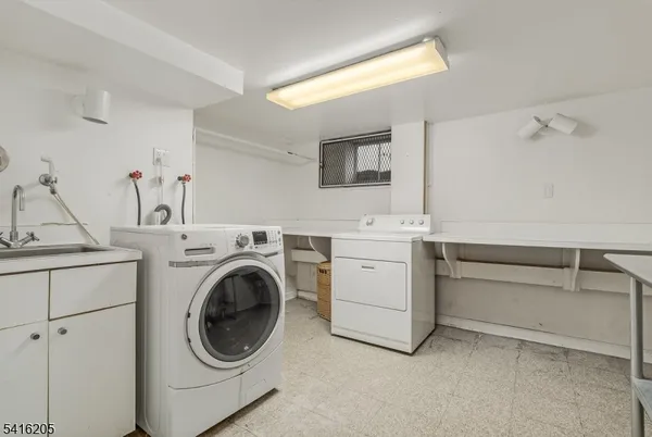 a utility room with sink dryer and washer