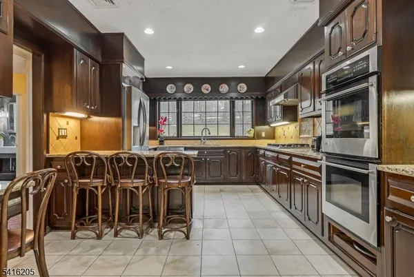 a kitchen with lots of counter top space appliances and a center island