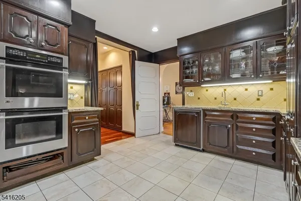 a kitchen with stainless steel appliances granite countertop a stove microwave and cabinets