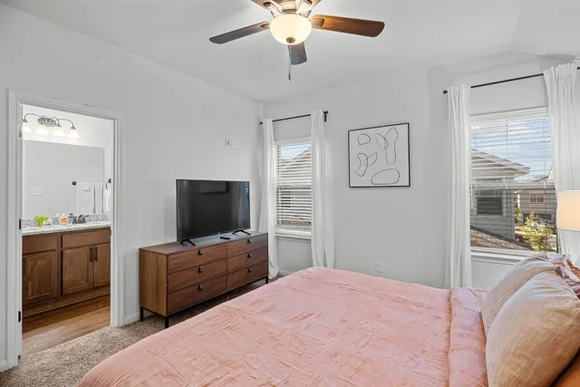 a bedroom with a bed and a television