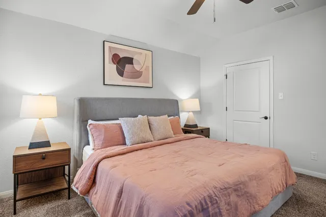 a bedroom with a bed and a lamp