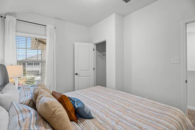 a bedroom with a bed and a window