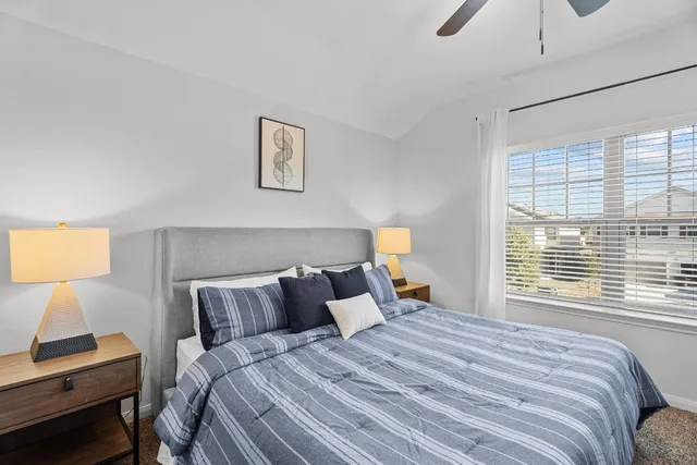 a bedroom with a bed and a window