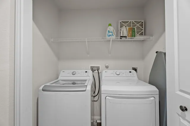 a view of storage and utility room with washer and dryer