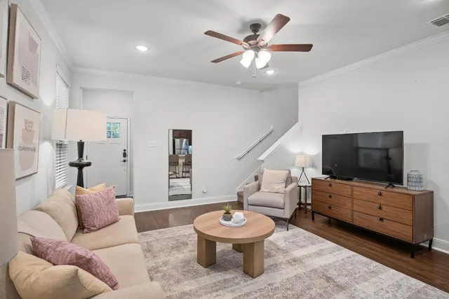 a living room with furniture and a flat screen tv