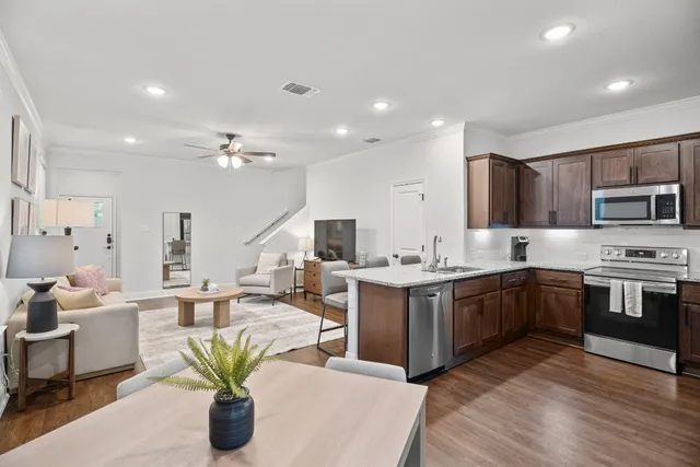 a large kitchen with kitchen island a sink a counter space and stainless steel appliances