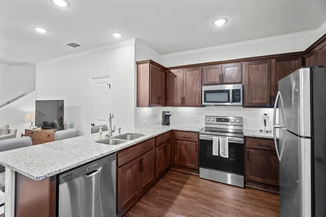 a kitchen with a sink stove and refrigerator