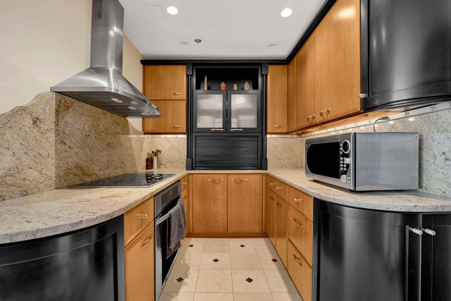 a kitchen with stainless steel appliances granite countertop a sink a stove and a microwave