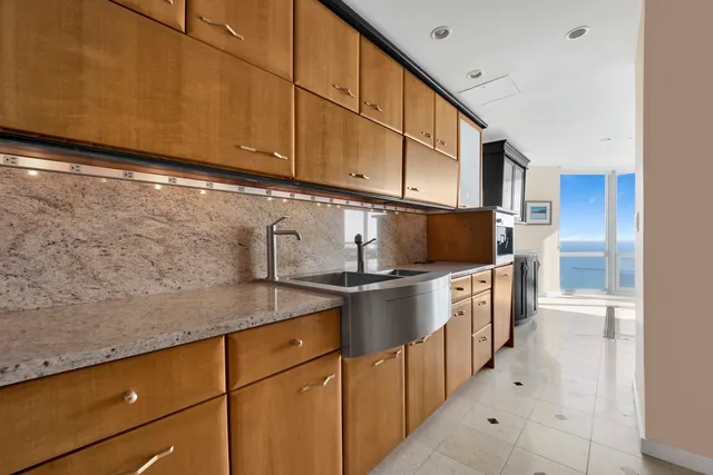 a kitchen with stainless steel appliances granite countertop a refrigerator and a stove