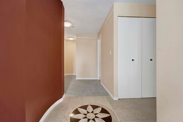 a view of hallway with a door and a rug