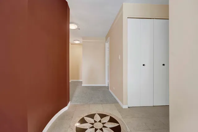 a view of hallway with a door and a rug