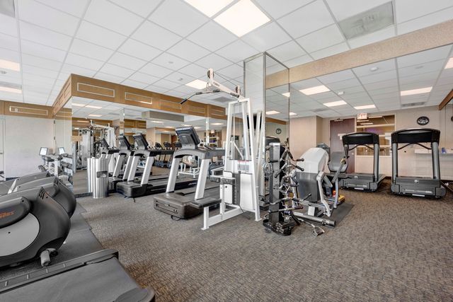 a room with table chairs and wooden walls