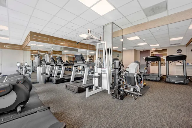 a room with table chairs and wooden walls